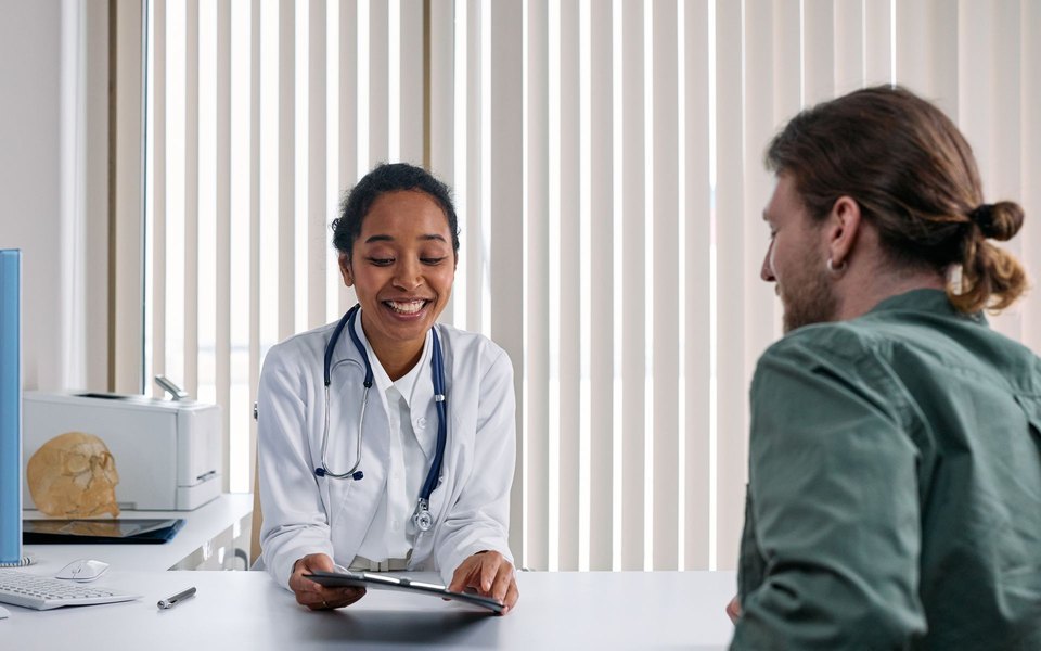 A provider answering a client’s questions across a desk